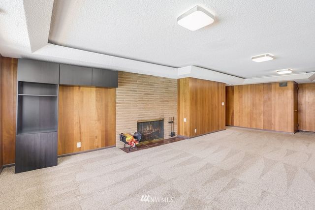 a view of an empty room with a fireplace