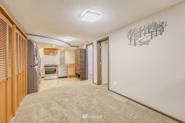 a view of a livingroom with furniture and a refrigerator