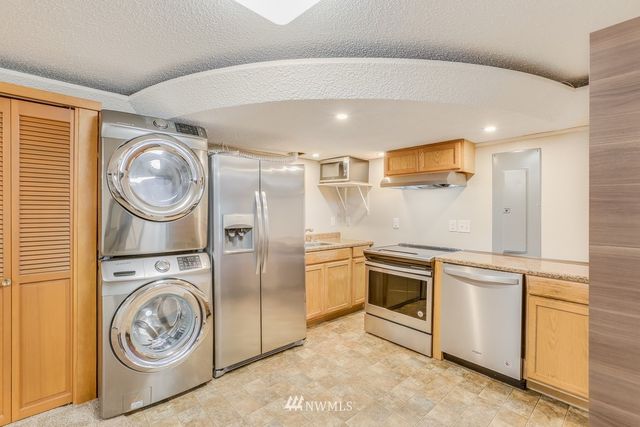 a utility room with sink dryer and washer
