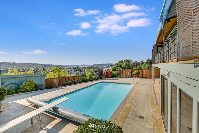 a view of swimming pool with outdoor seating and plants