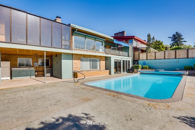 a view of a brick wall next to a building