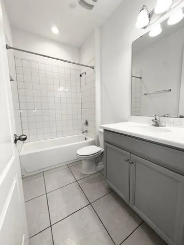 a spacious bathroom with a sink and a mirror