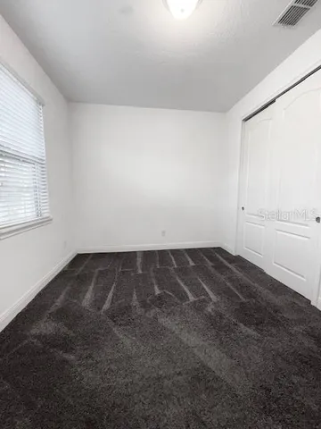 an empty room with a empty space and windows