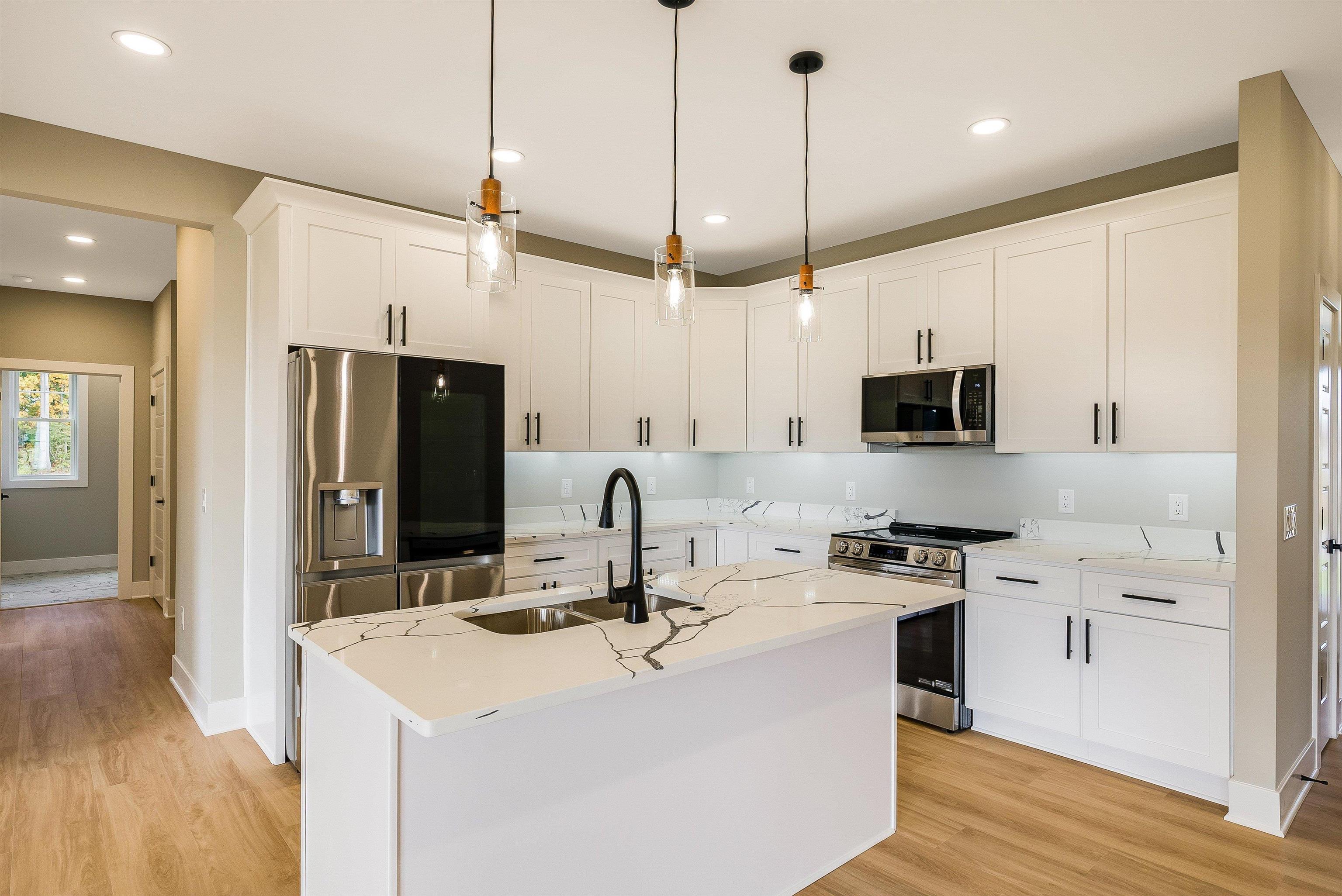 4935 Boxer Loop McGaheysville, VA 22840 - Photo 11 of 60 a kitchen with kitchen island a sink appliances and wooden floor