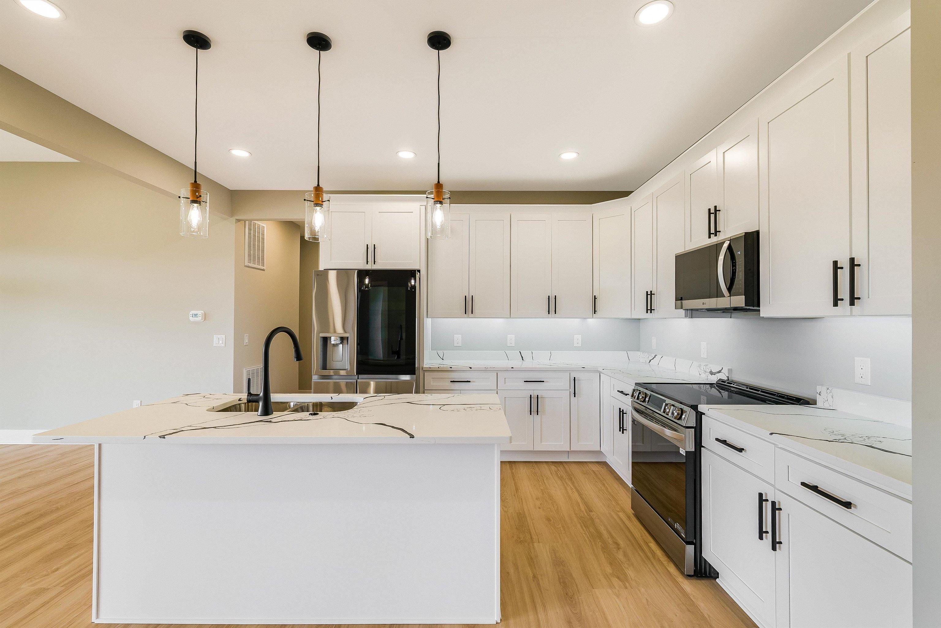 4935 Boxer Loop McGaheysville, VA 22840 - Photo 12 of 60 a kitchen with stainless steel appliances kitchen island a large island in the center