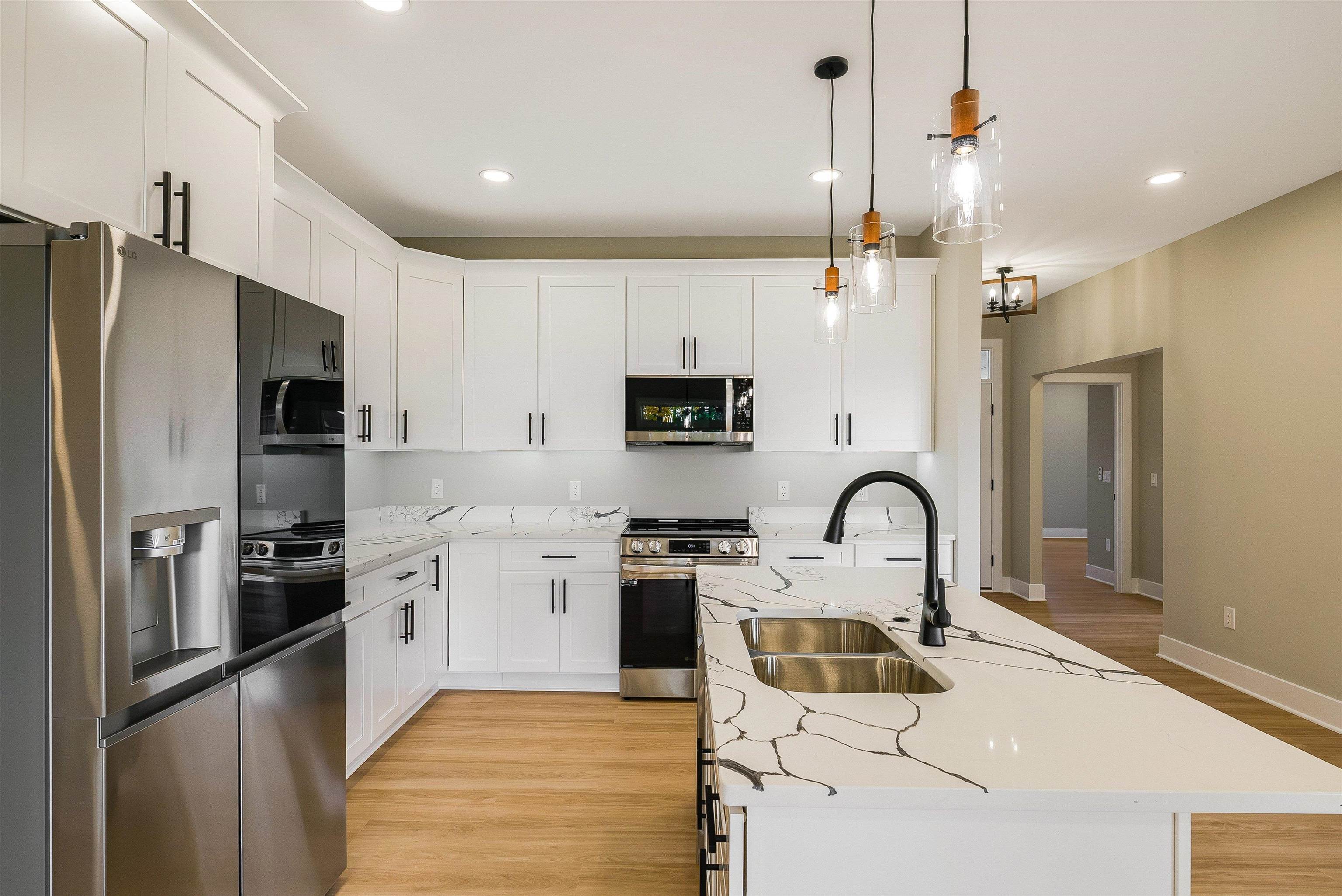 4935 Boxer Loop McGaheysville, VA 22840 - Photo 13 of 60 a kitchen with stainless steel appliances kitchen island a refrigerator sink and white cabinets