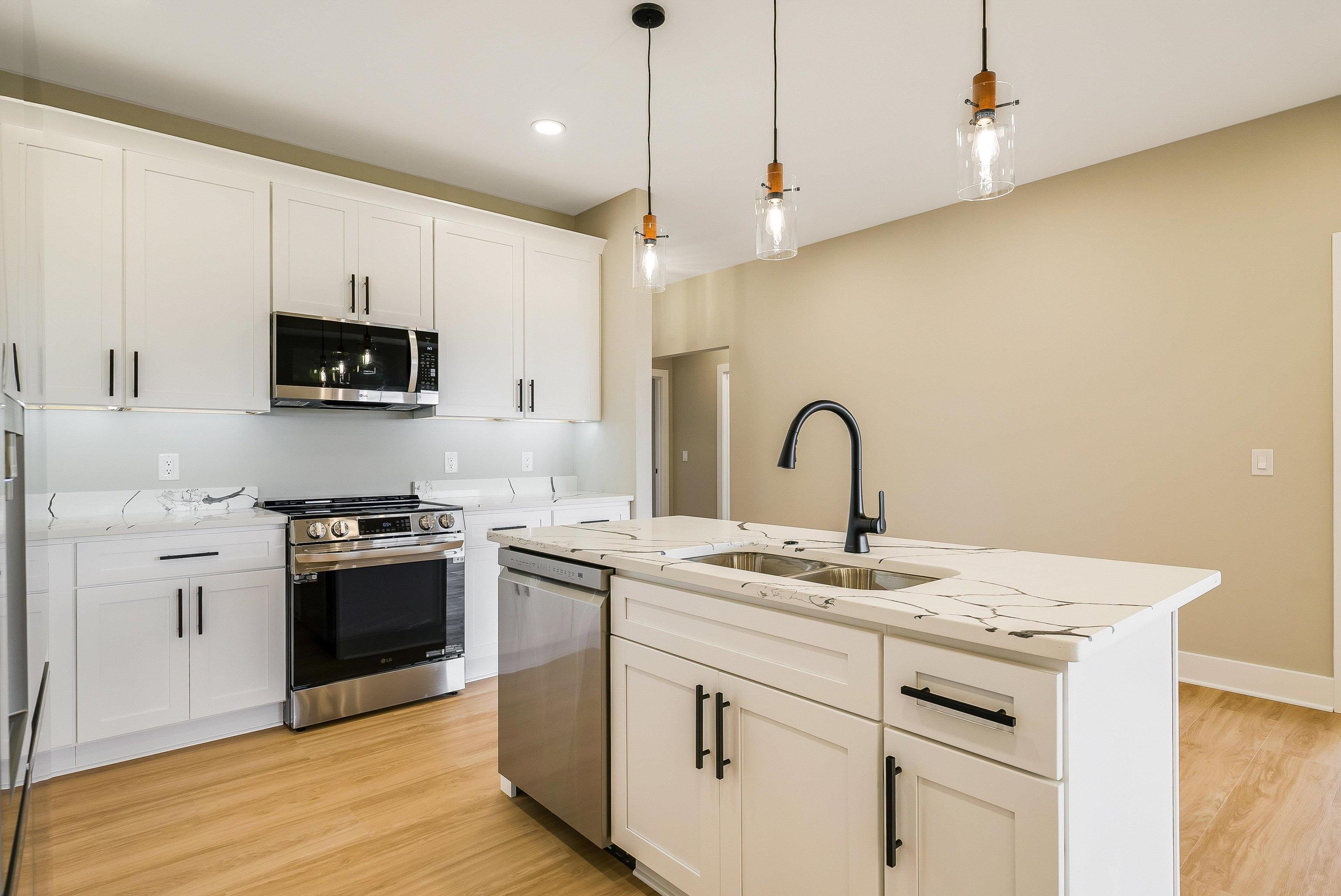 4935 Boxer Loop McGaheysville, VA 22840 - Photo 14 of 60 a kitchen with stainless steel appliances granite countertop a stove a sink and a microwave