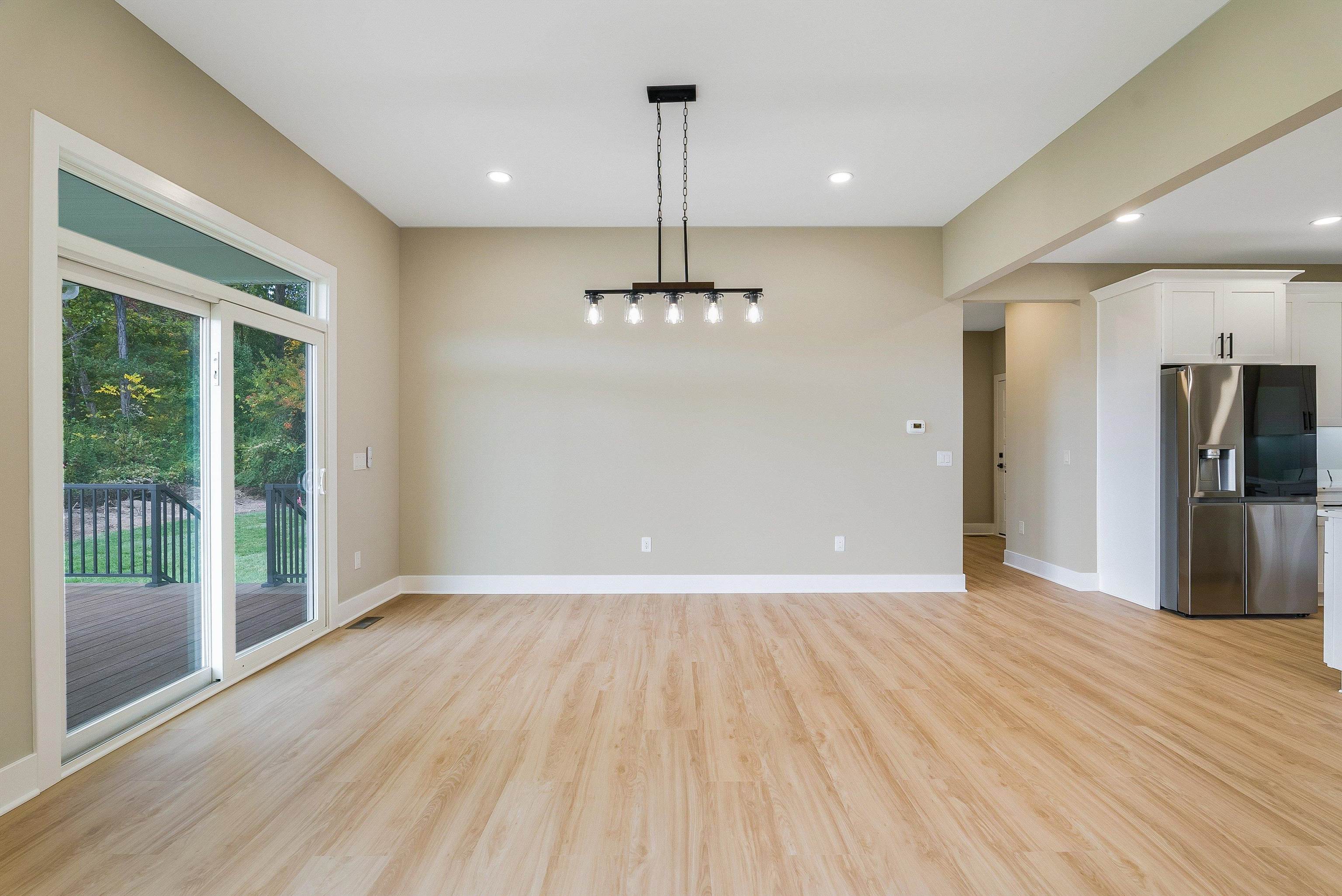 4935 Boxer Loop McGaheysville, VA 22840 - Photo 22 of 60 a view of a room with wooden floor a ceiling fan and windows