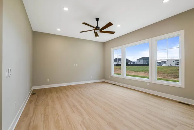 a bedroom with a large bed and a window
