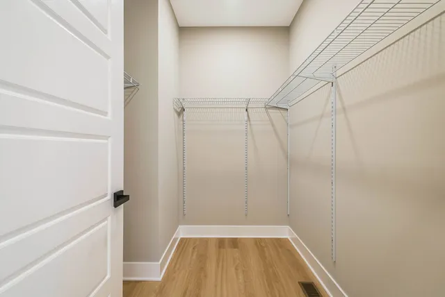 a bedroom with a bed and a lamp