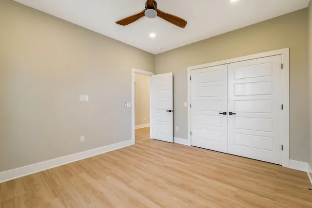 a spacious bedroom with a bed and a couch