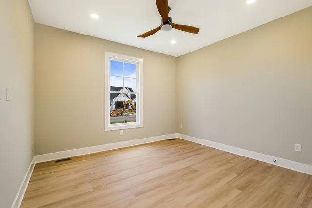 a bathroom with a granite countertop sink toilet and mirror