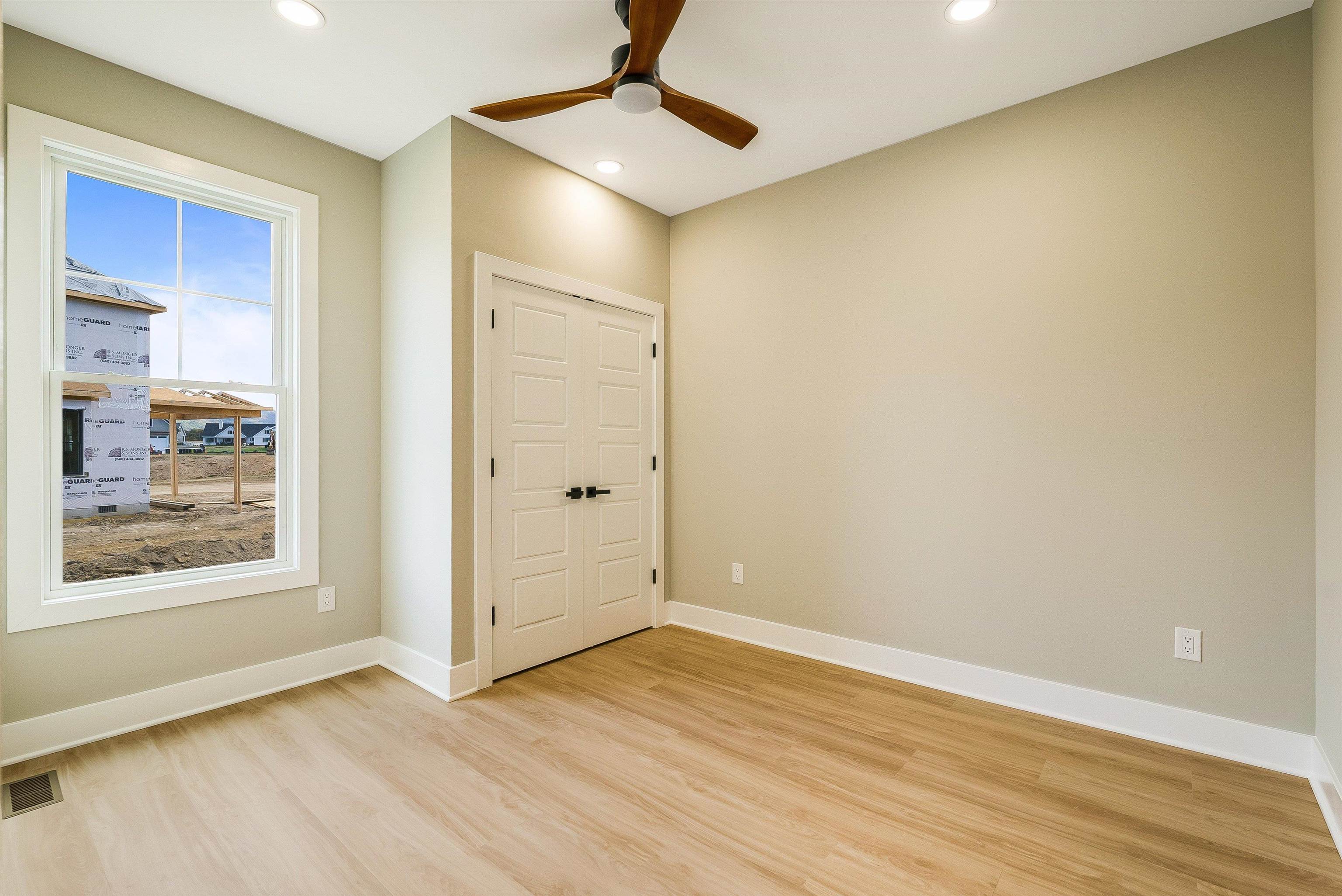 4935 Boxer Loop McGaheysville, VA 22840 - Photo 44 of 60 an empty room with wooden floor and windows