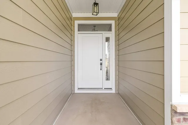 a large kitchen with kitchen island a white cabinets and wooden floor