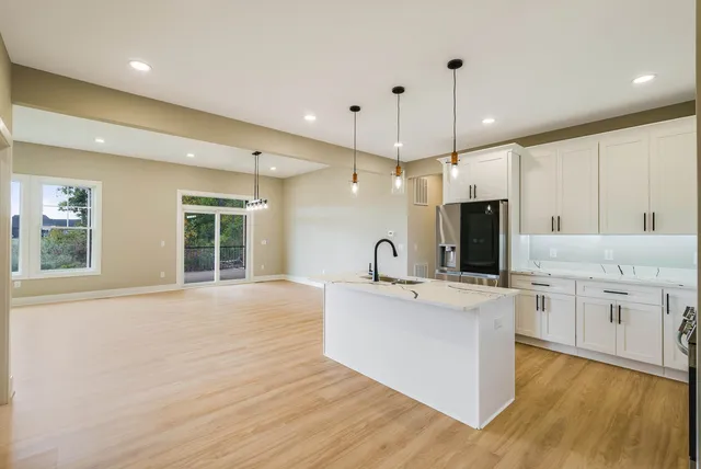 a kitchen with stainless steel appliances kitchen island a large island in the center