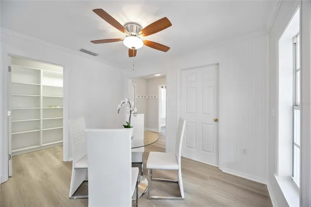 a living room with fireplace furniture and a large window