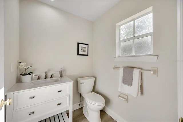 a dining room with furniture potted plants and wooden floor