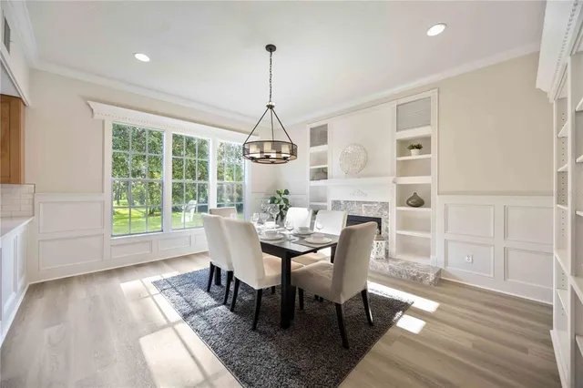 a dining room with furniture potted plants and wooden floor