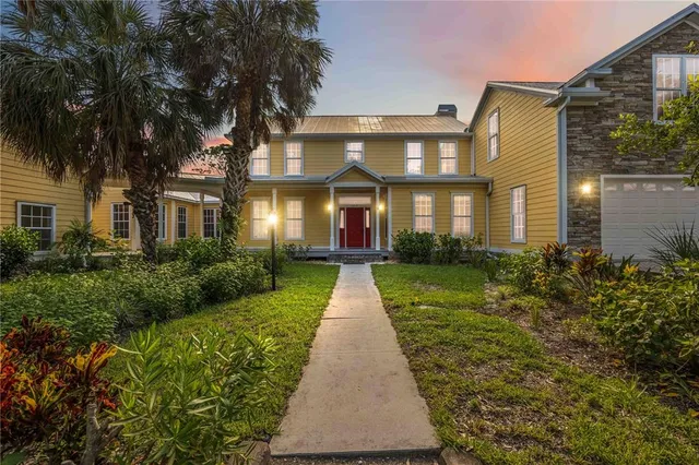 front view of a brick house with a yard