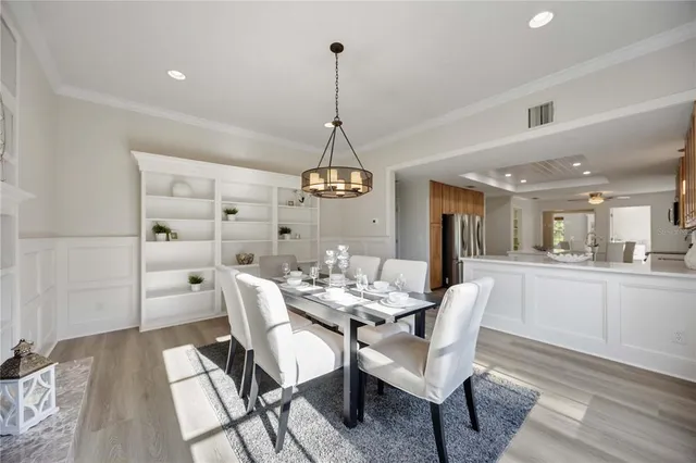 a living room with furniture flat screen tv and a large window