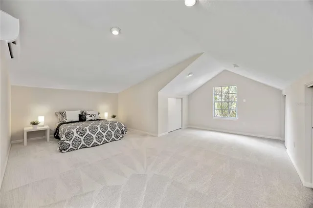 a bedroom with a bed and a night stand