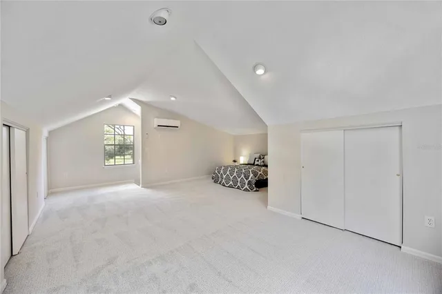 a spacious bedroom with a large bed and a window