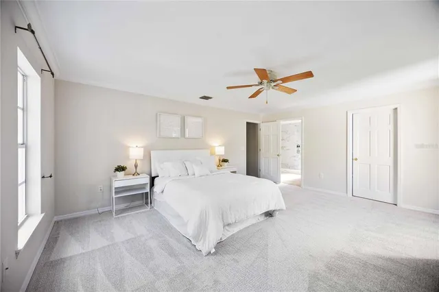 a spacious bathroom with a double vanity sink a large mirror and shower