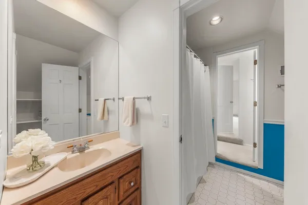 a spacious bathroom with a granite countertop sink and a mirror