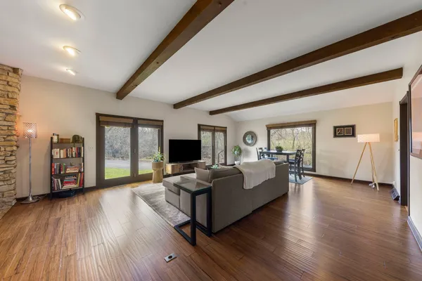 a living room with furniture and a wooden floor