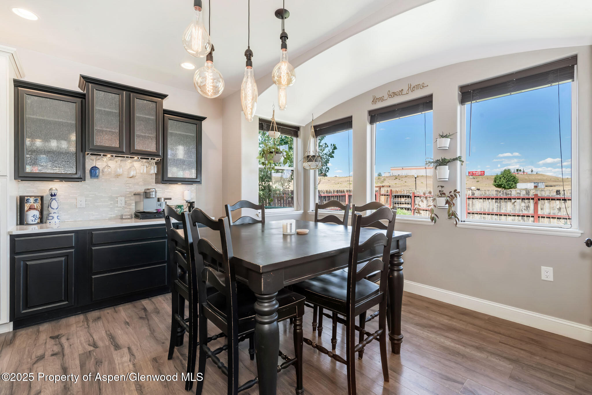 875 Dry Creek Road Hayden, CO 81639 - Photo 14 of 40 a view of a dining room with furniture window and wooden floor