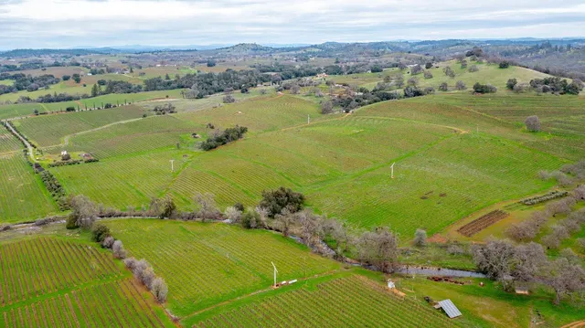 an aerial view of a residential houses with outdoor space