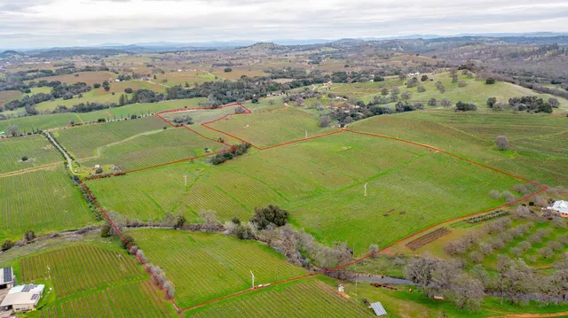 an aerial view of a residential houses with outdoor space