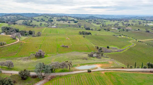 an aerial view of a residential houses with outdoor space