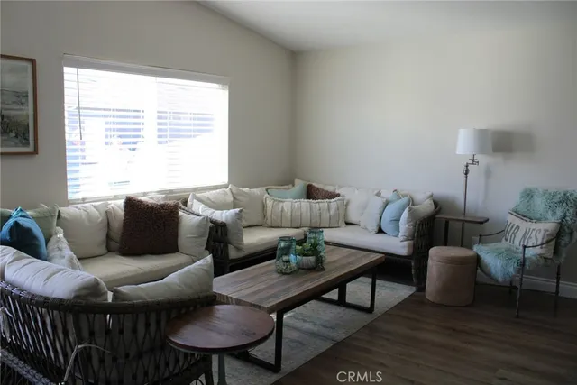 a living room with furniture a window and a table