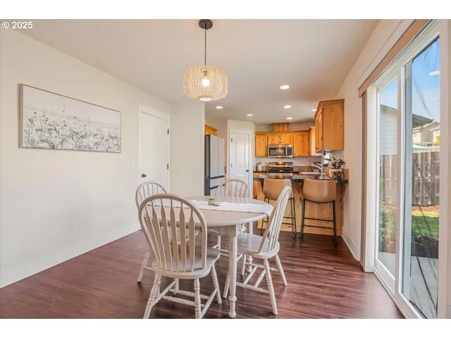 a view of a dining room with furniture wooden floor and chandelier