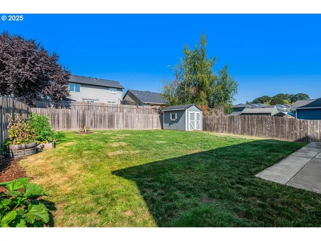 a backyard of a house with table and chairs