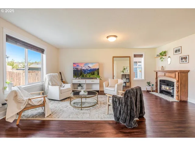 a living room with furniture a flat screen tv and a fireplace