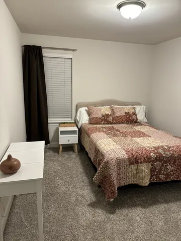 a bedroom with a bed and a table