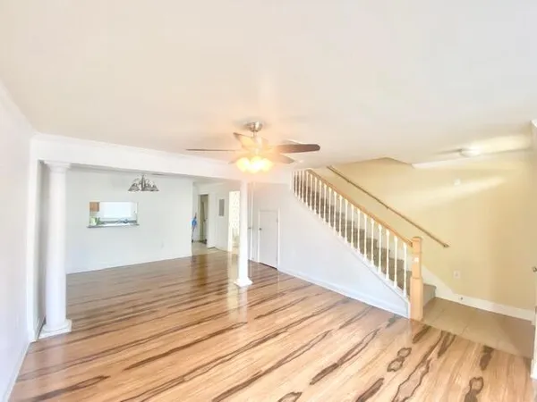 a view of an empty room with wooden floor