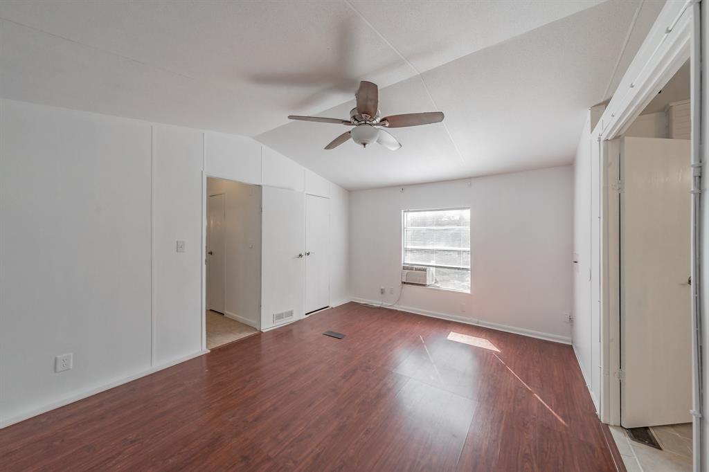 417 Wood River Road Millsap, TX 76066 - Photo 11 of 40 an empty room with wooden floor and windows
