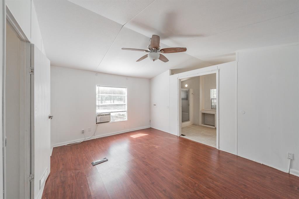 417 Wood River Road Millsap, TX 76066 - Photo 10 of 40 an empty room with wooden floor and windows