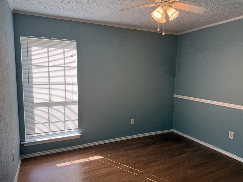 2414 March Lane Grand Prairie, TX 75050 - Photo 11 of 15 an empty room with wooden floor and windows