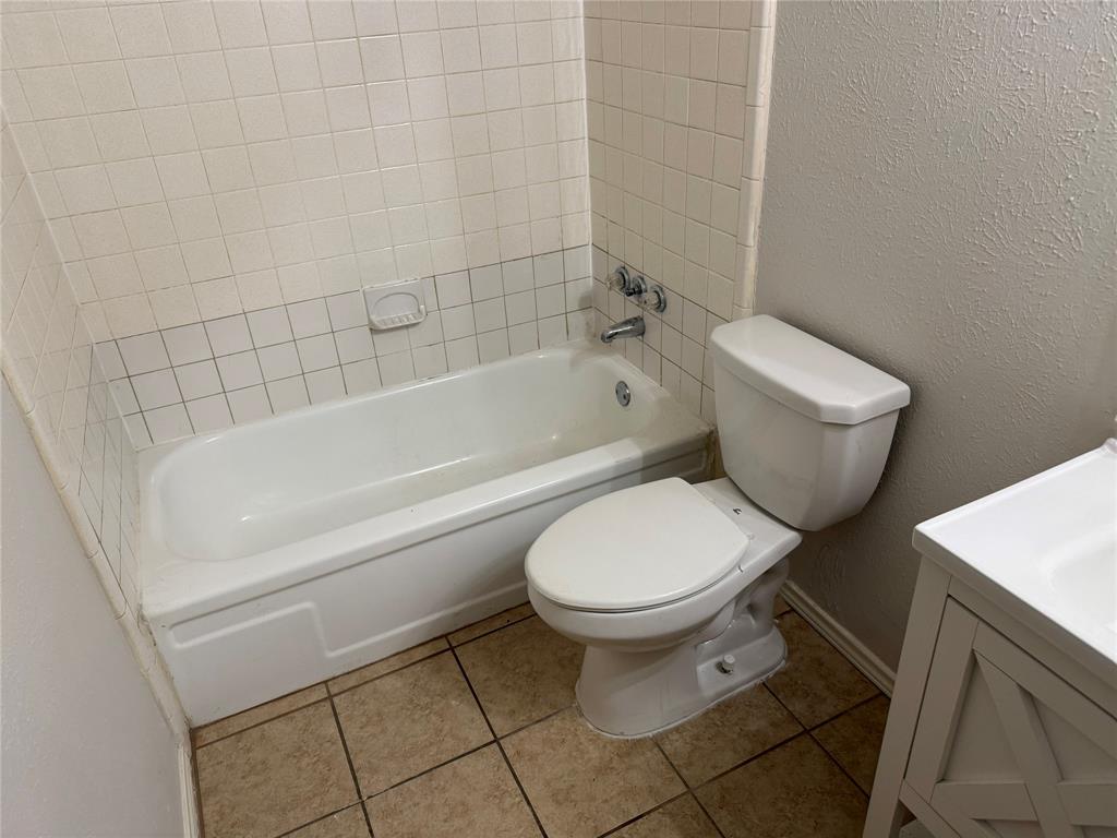 2414 March Lane Grand Prairie, TX 75050 - Photo 13 of 15 a bathroom with a toilet and a bathtub