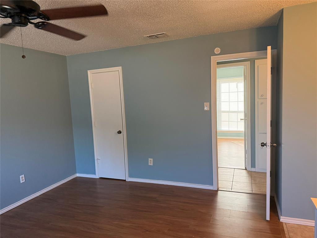 2414 March Lane Grand Prairie, TX 75050 - Photo 6 of 15 a view of an empty room with wooden floor