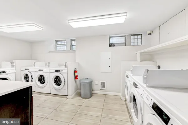 a utility room with dryer washer and sink