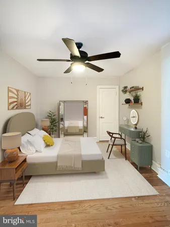 a bedroom with a bed a chandelier and a dresser