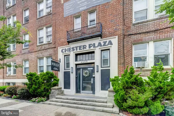 a view of a brick building with potted plants