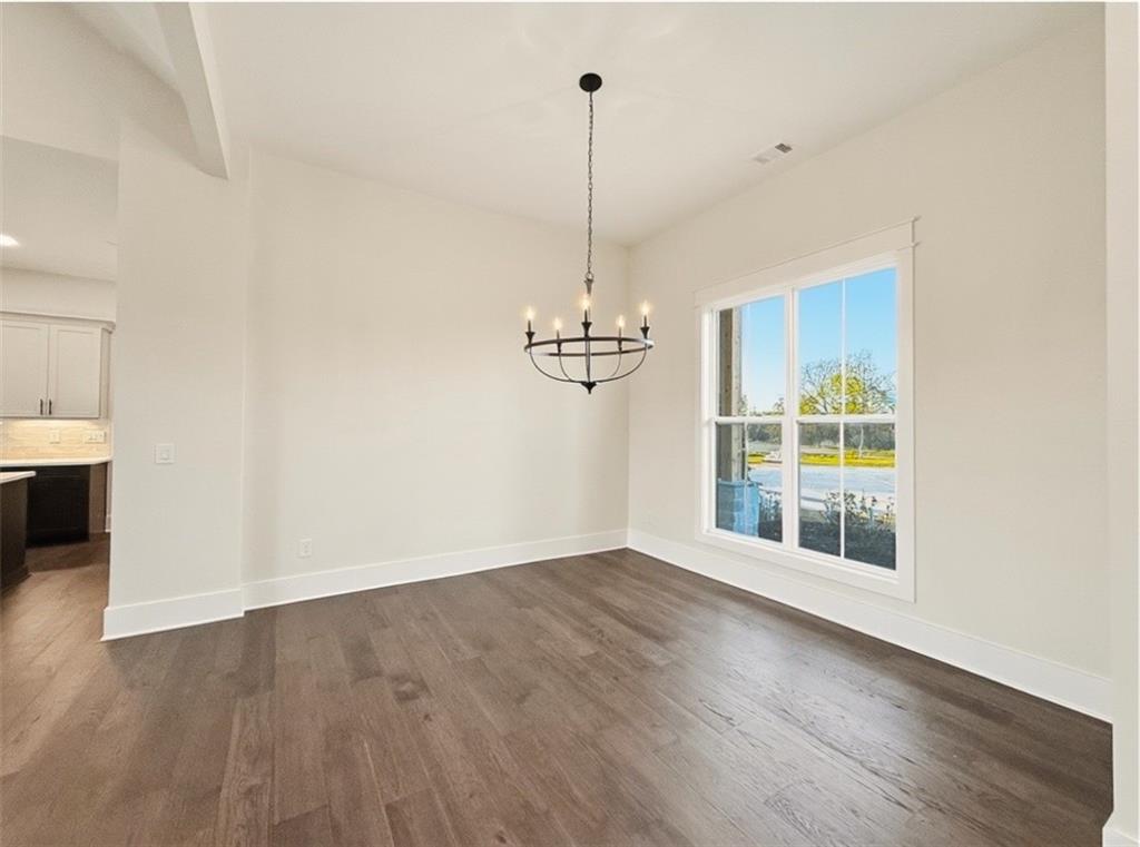 303 Eminence Peak Rydal, GA 30171 - Photo 19 of 73 a view of a room with wooden floor ceiling fan and windows