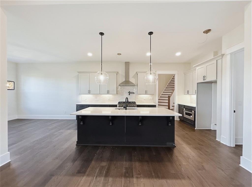 303 Eminence Peak Rydal, GA 30171 - Photo 28 of 73 a view of kitchen with stainless steel appliances granite countertop a sink a oven and a wooden floors