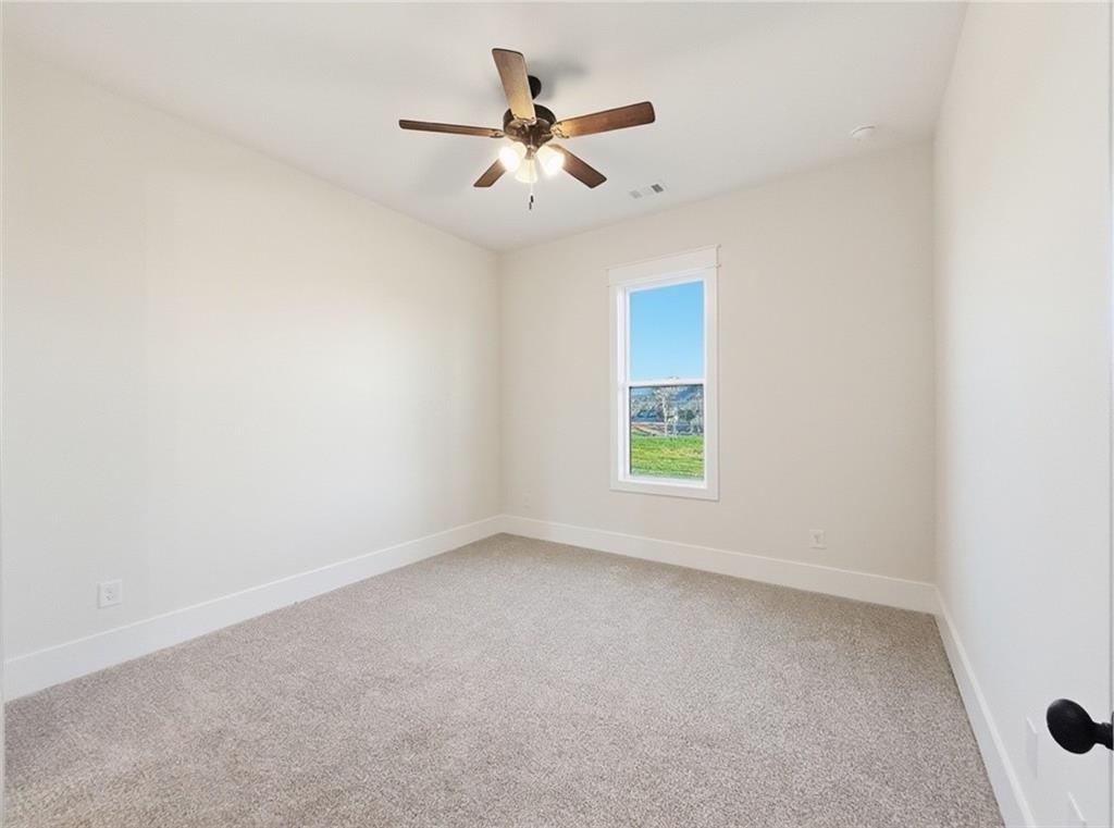 303 Eminence Peak Rydal, GA 30171 - Photo 55 of 73 an empty room with a window and a ceiling fan